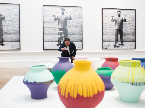 Ai Weiwei taking a photograph of his installation Coloured Vases